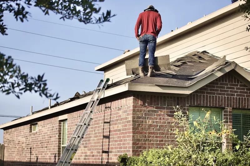 Professional roofer working on a residential roof in Atascosa